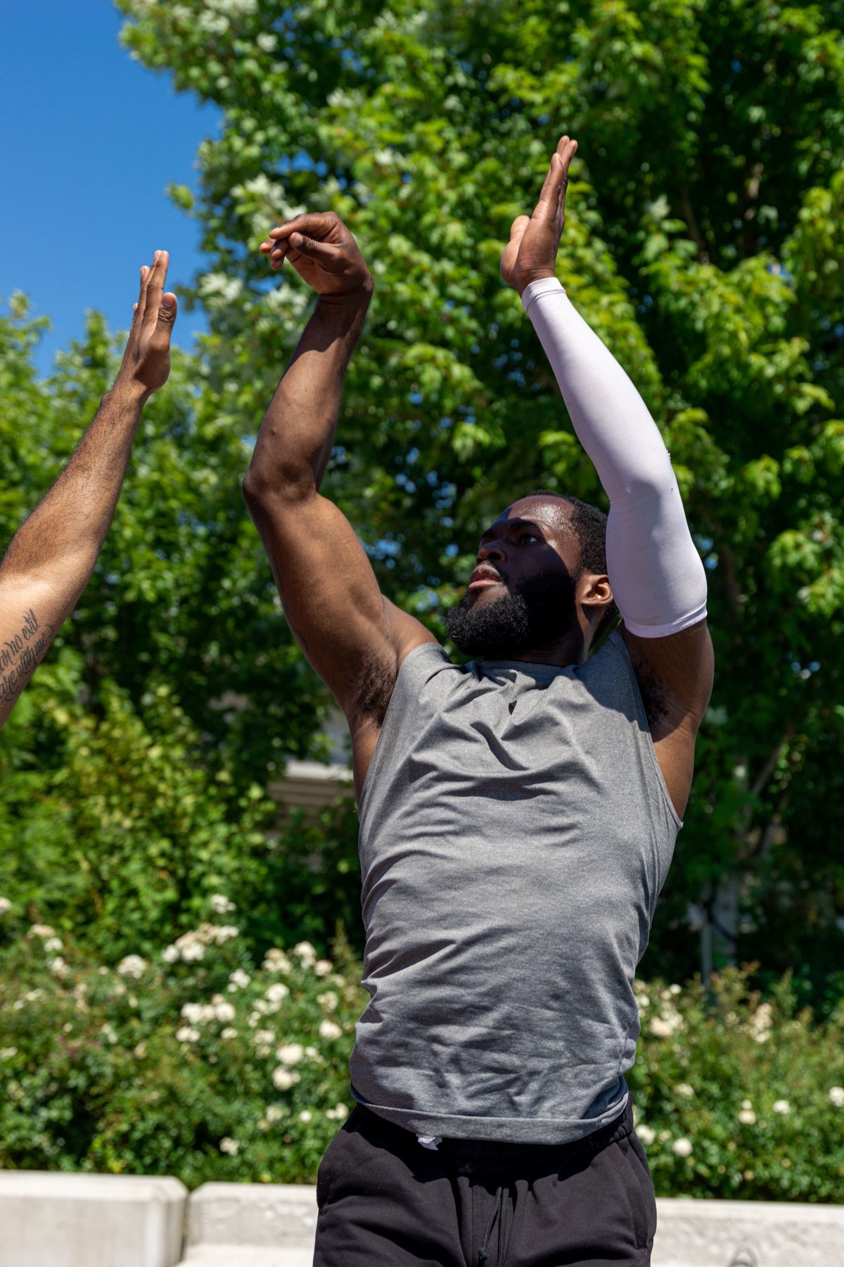Volleyball players reaching for the ball outdoors